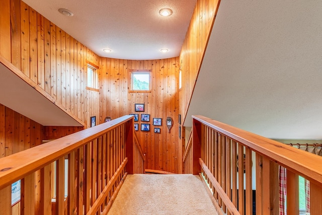 corridor with carpet flooring and a textured ceiling