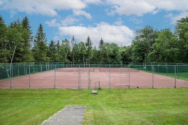 view of sport court featuring a yard