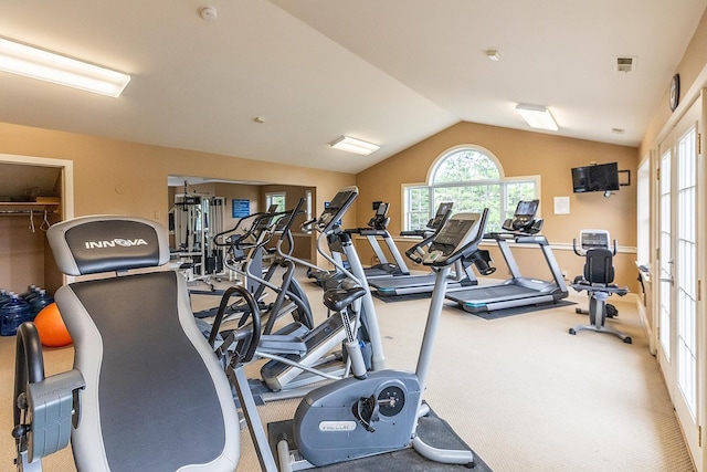 workout area with carpet and vaulted ceiling