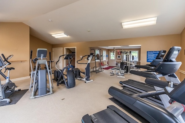 workout area with carpet flooring and vaulted ceiling