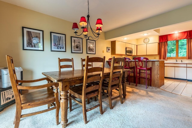 dining room featuring light carpet and an inviting chandelier