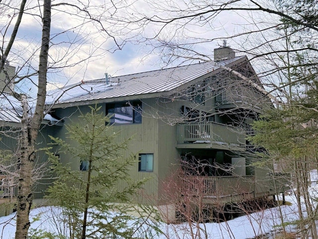 view of side of property with a balcony