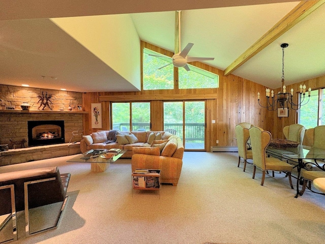 carpeted living room featuring a stone fireplace, wood walls, baseboard heating, beam ceiling, and ceiling fan with notable chandelier