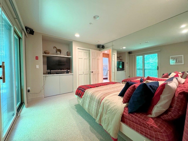 bedroom featuring multiple windows and light carpet