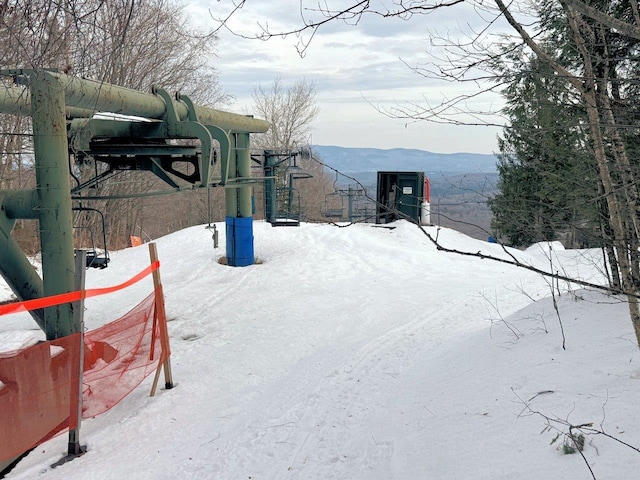 snowy yard featuring a mountain view