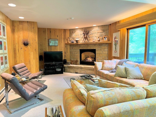 carpeted living room featuring a fireplace and wooden walls