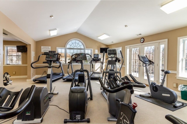 workout area featuring french doors, lofted ceiling, and light carpet