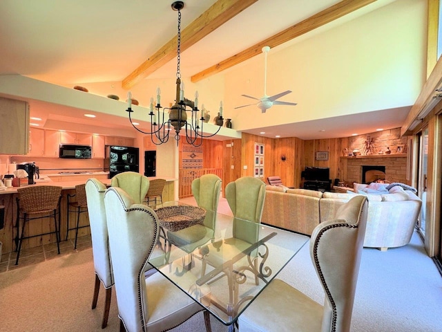 dining area with wooden walls, high vaulted ceiling, beamed ceiling, light colored carpet, and a chandelier