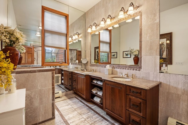 bathroom with vanity, tile walls, and a baseboard heating unit