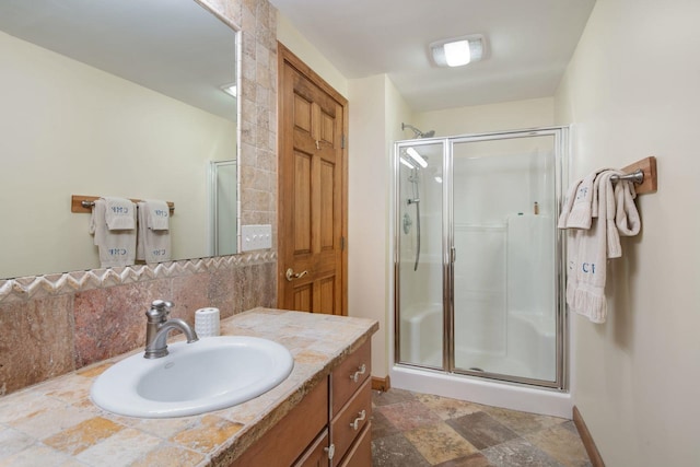 bathroom with vanity and a shower with shower door