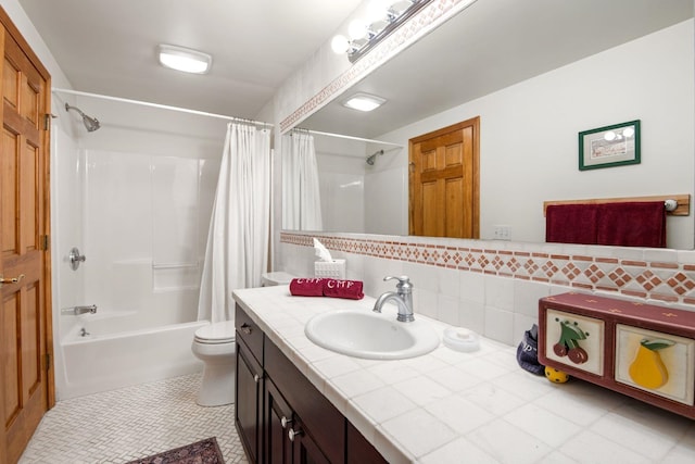 full bathroom featuring tile patterned flooring, toilet, shower / tub combo with curtain, vanity, and tile walls