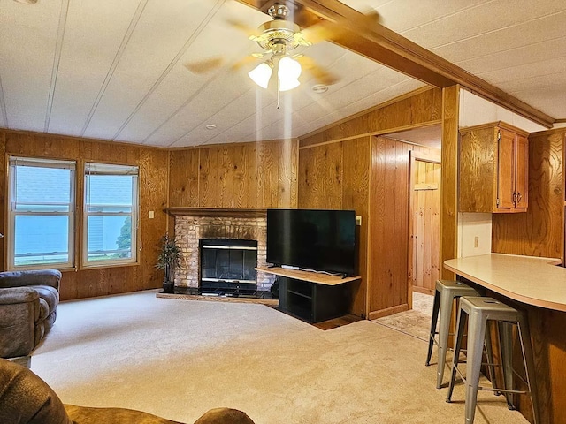 living room with lofted ceiling, wooden walls, and light colored carpet