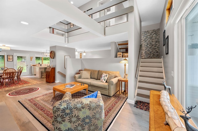 living area with stairs, recessed lighting, light wood-type flooring, and baseboards