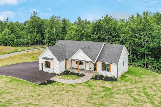 view of front of property with a front yard and covered porch