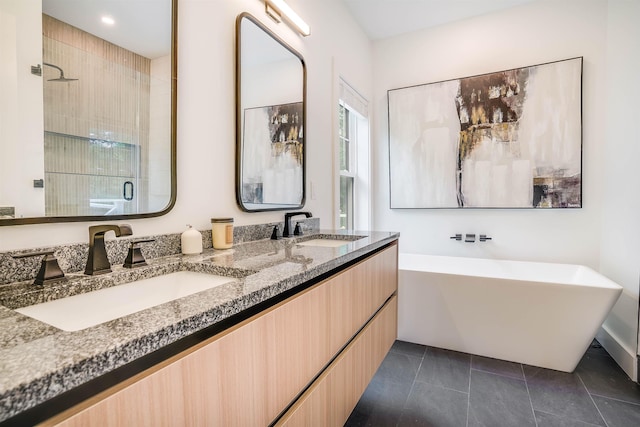 bathroom with tile patterned floors, vanity, and shower with separate bathtub