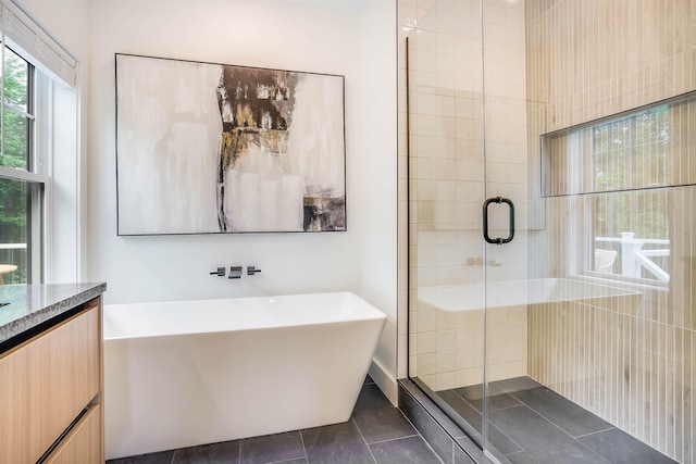 bathroom featuring tile patterned flooring, vanity, and separate shower and tub