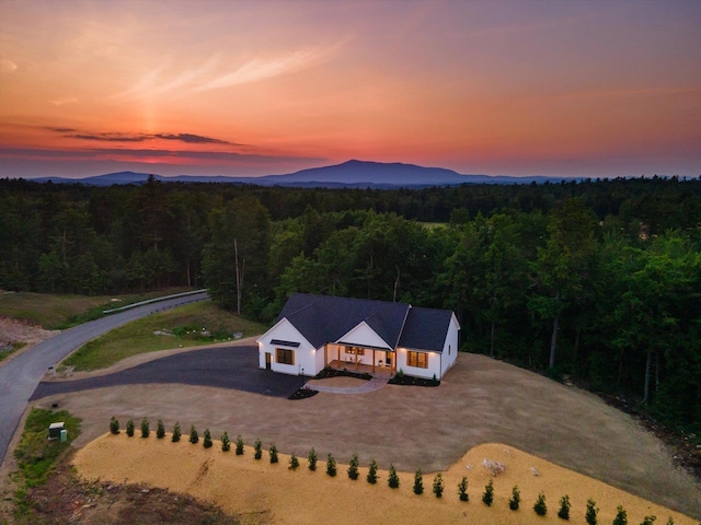 aerial view at dusk featuring a mountain view