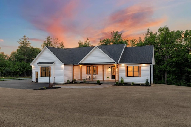 modern farmhouse style home featuring covered porch