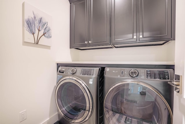 laundry area featuring cabinets and separate washer and dryer