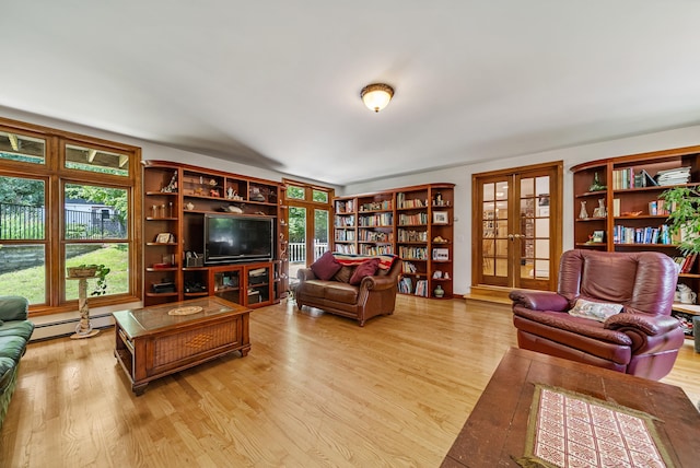 living room featuring a baseboard heating unit, french doors, and wood finished floors