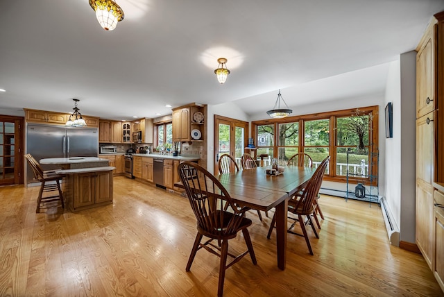 dining area featuring lofted ceiling, light wood-type flooring, a baseboard radiator, and recessed lighting