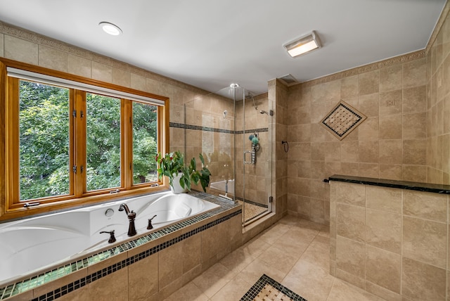 bathroom with tile patterned flooring, a shower stall, tile walls, and a bath