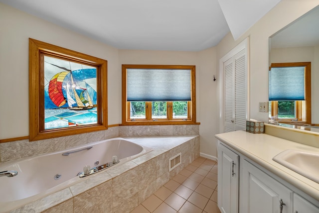 bathroom with tile patterned flooring, vanity, visible vents, a closet, and a whirlpool tub