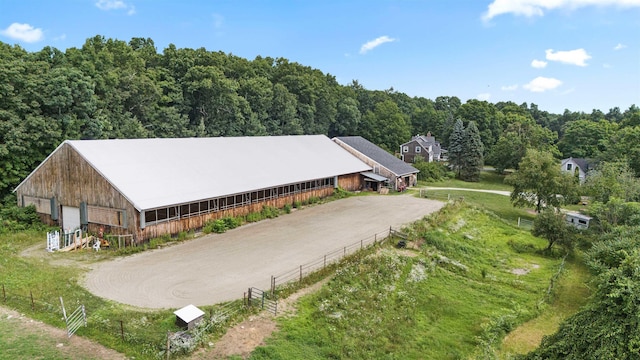 birds eye view of property featuring a view of trees