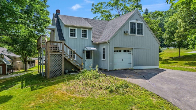 view of front of property featuring a garage, driveway, a shingled roof, a chimney, and a front yard