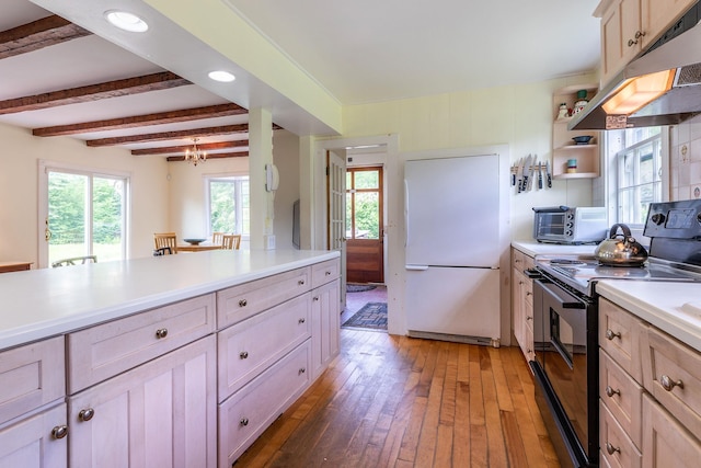 kitchen featuring dark wood-type flooring, beam ceiling, light brown cabinetry, black / electric stove, and white fridge