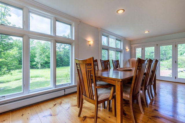 dining area featuring hardwood / wood-style floors and a baseboard radiator