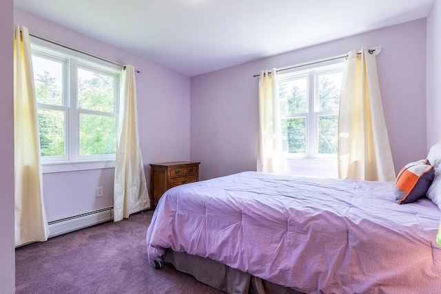 carpeted bedroom featuring baseboard heating and multiple windows