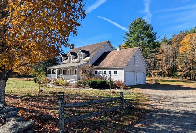 cape cod house with covered porch and a front lawn