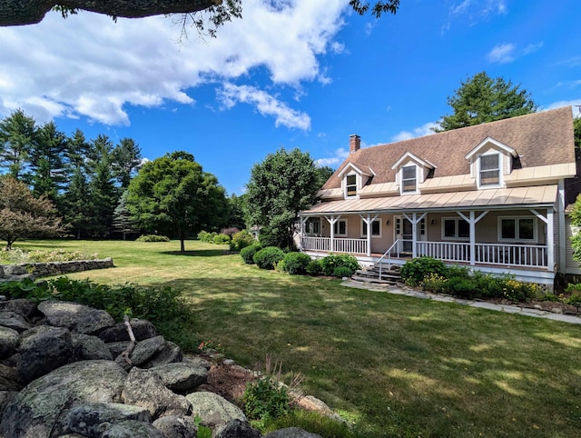 farmhouse-style home featuring a porch and a front yard