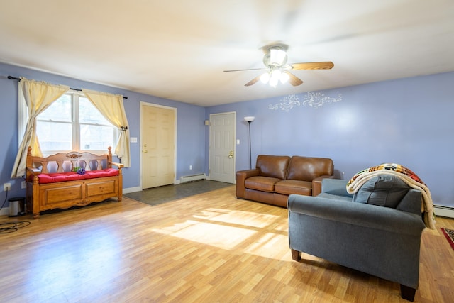 living room featuring hardwood / wood-style flooring, ceiling fan, and a baseboard heating unit