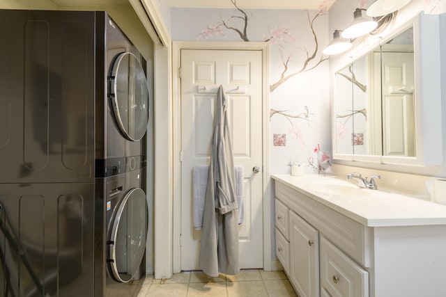 bathroom featuring stacked washer / dryer, vanity, and tile patterned floors