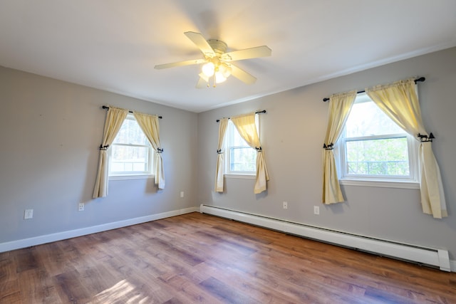 unfurnished room featuring a baseboard heating unit, wood-type flooring, and ceiling fan