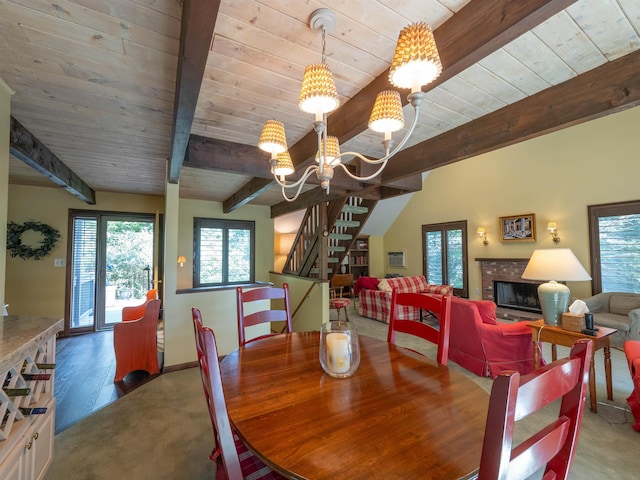 dining space with wood ceiling, a fireplace, beamed ceiling, and a chandelier