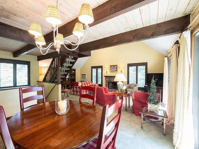 dining room featuring a healthy amount of sunlight, light colored carpet, a brick fireplace, and a notable chandelier