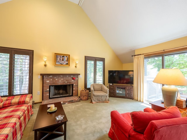 carpeted living room with a wealth of natural light, high vaulted ceiling, and a brick fireplace