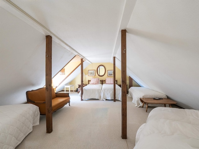 bedroom with light colored carpet and vaulted ceiling