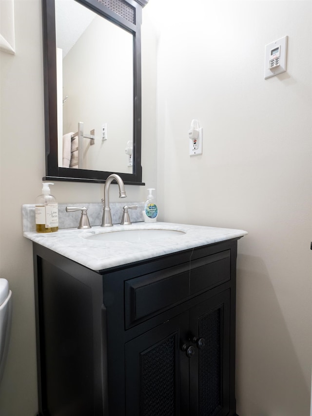 bathroom with vanity and toilet