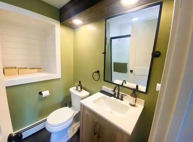 bathroom with a baseboard radiator, vanity, and toilet