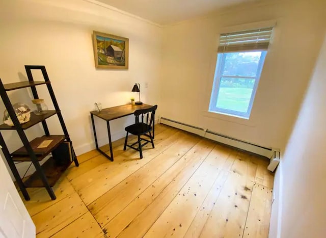 home office featuring wood-type flooring and a baseboard heating unit