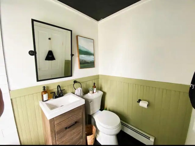 bathroom featuring baseboard heating, toilet, and vanity