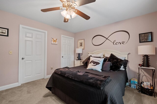 bedroom featuring light carpet and ceiling fan