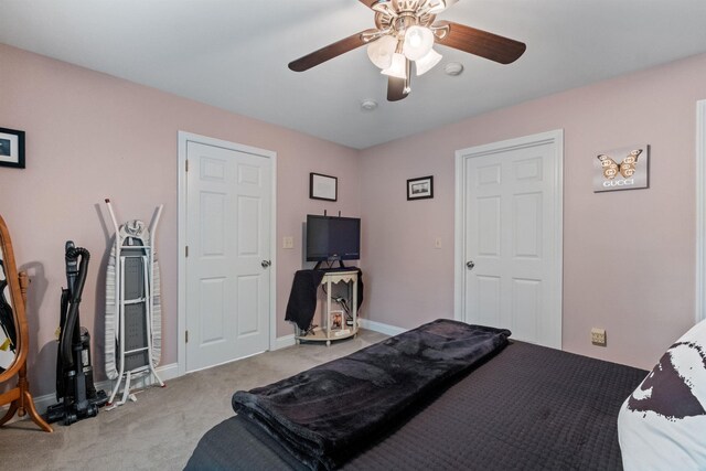 bedroom with ceiling fan and light carpet