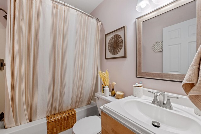 full bathroom with vanity, toilet, and shower / bath combo with shower curtain