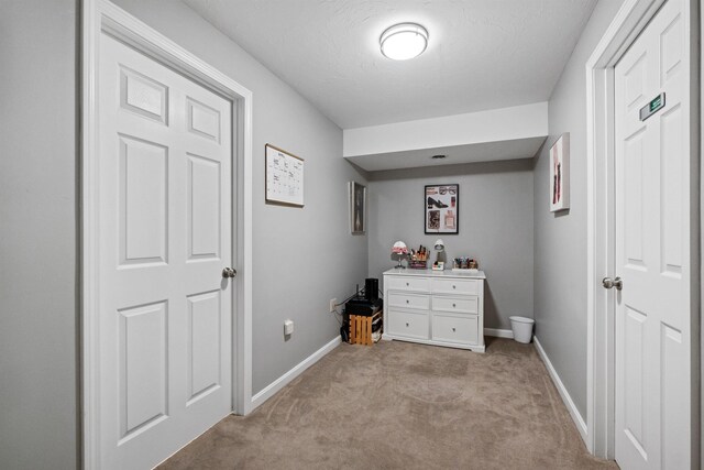 hall with light colored carpet