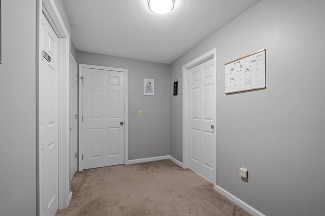 corridor with light colored carpet